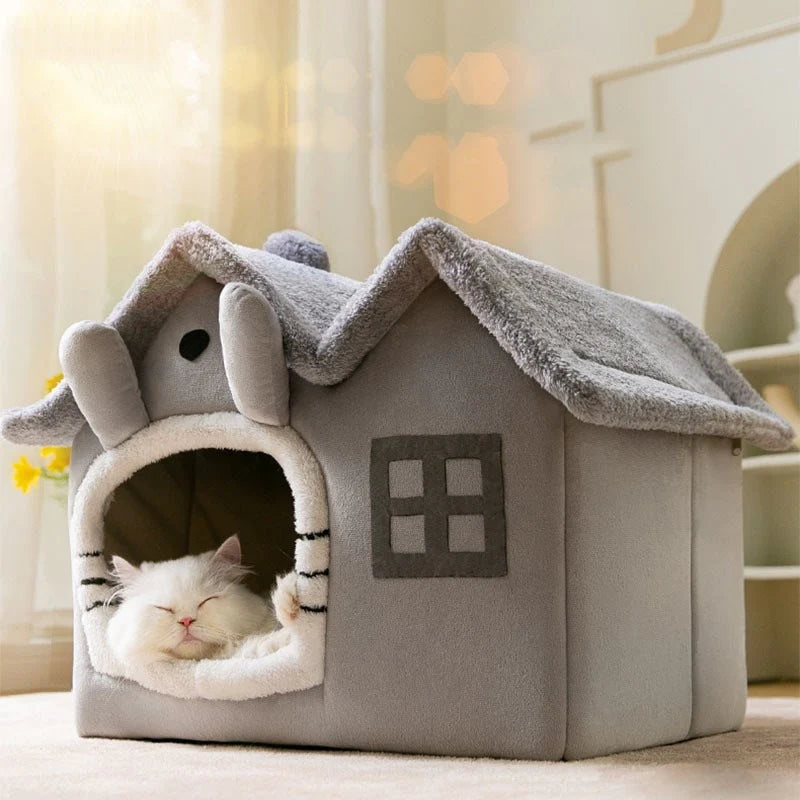 Cat sleeping in a cozy gray pet house with a small window and entrance.