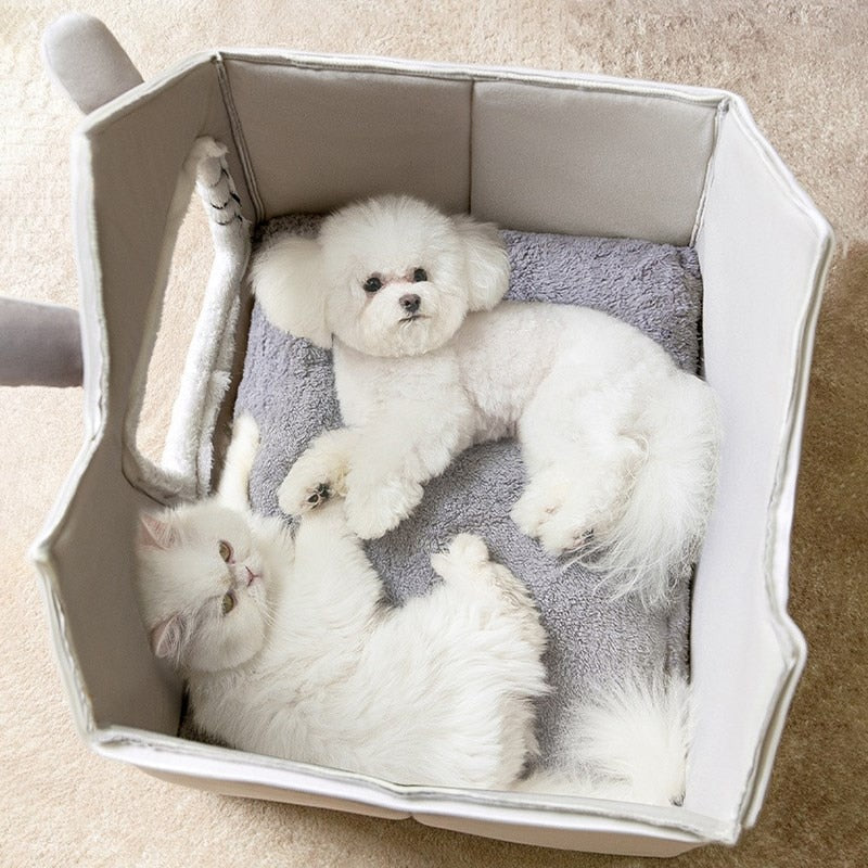 Two white dogs in a hexagonal pet bed on a beige carpet.